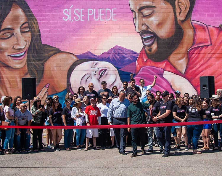 Maryvale One Square Mile Initiative - group of people cutting a red ribbon and standing in front of a colorful mural