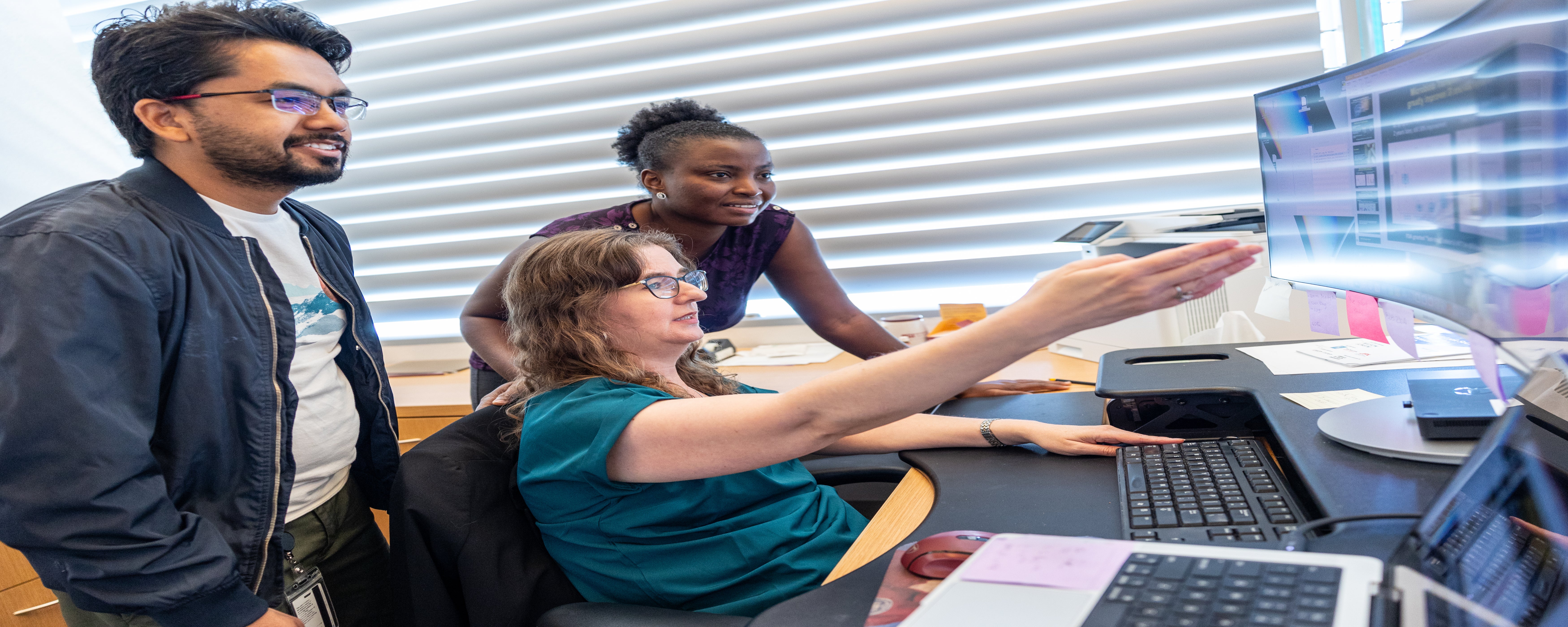 A Professor showing a student research information 