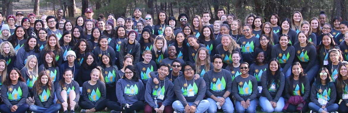 group of college students smiling and wearing Camp Co-op shirts