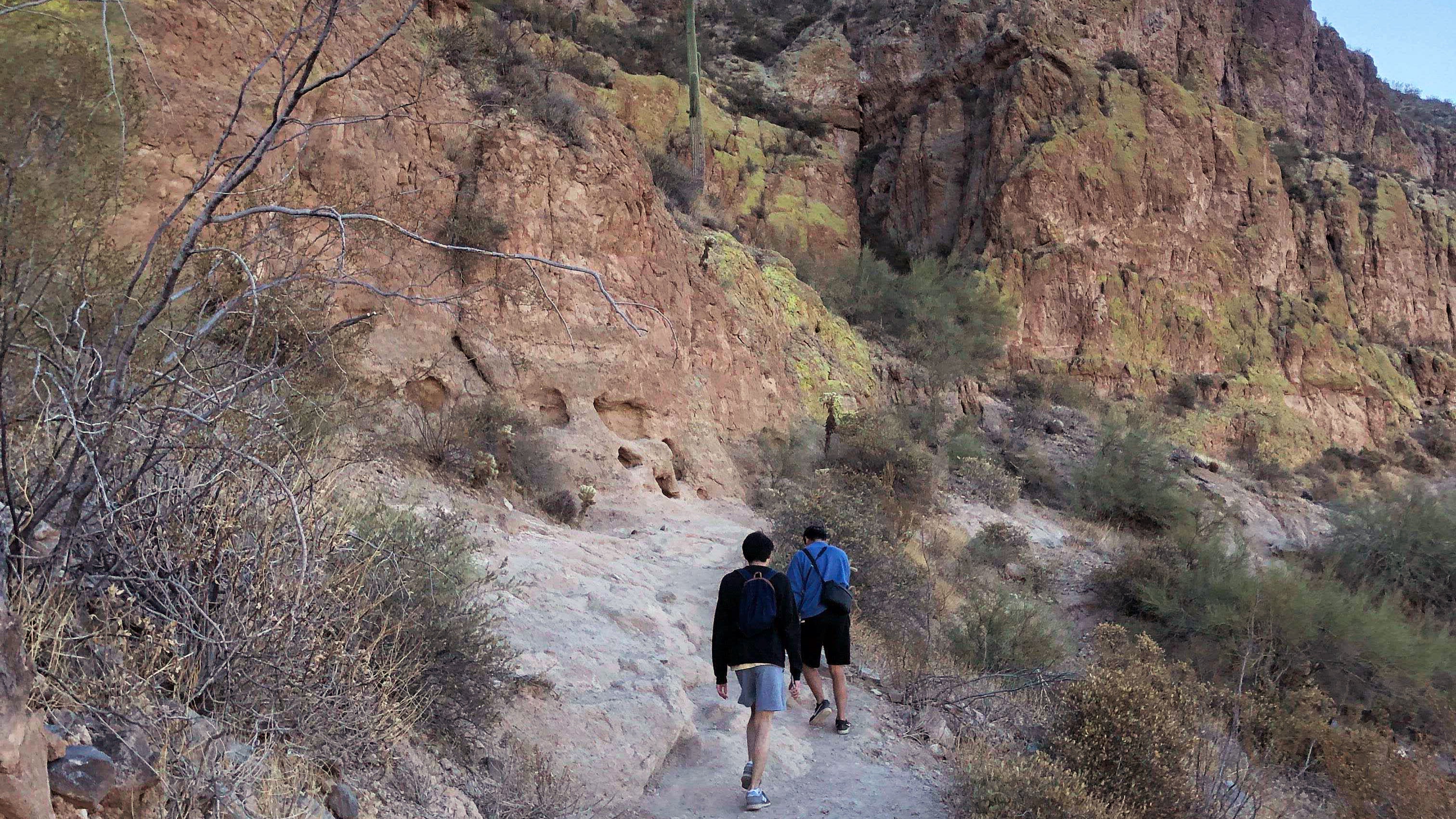 Image of two people hiking in the desert