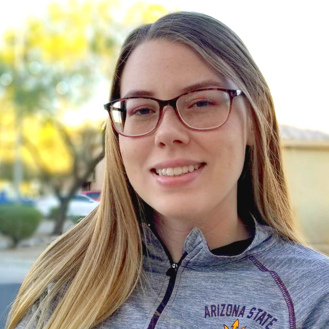 Young, fair-complexioned young woman with straight, dark-blond hair wears large glasses and heather gray ASU athletic jacket